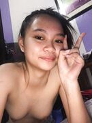 Cute tall Asian teen exposes her tits and pussy