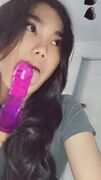 Sexy Asian chick licks her purple dildo