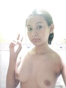 Nude posing in bathroom at home