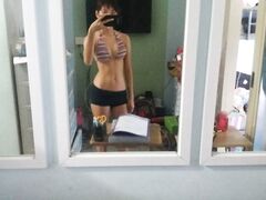 Hot slim Asian coed exposes her naked body to mirror