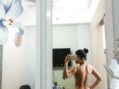 Hot slim Asian coed exposes her naked body to mirror