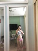 Hot slim Asian coed exposes her naked body to mirror