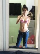 Hot slim Asian coed exposes her naked body to mirror