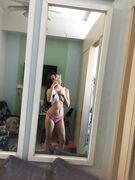 Hot slim Asian coed exposes her naked body to mirror