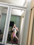 Hot slim Asian coed exposes her naked body to mirror