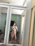 Hot slim Asian coed exposes her naked body to mirror